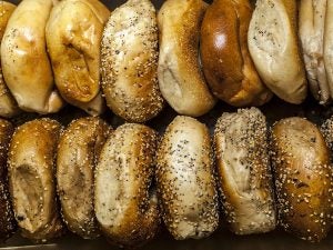 Two rows of Bruegger's Bagels coated with sesame seeds